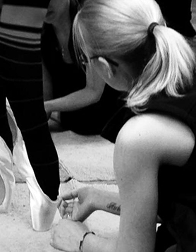 A member fo the Dancia London team fitting a pair of pointe shoes.